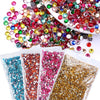 A collection of round flatback resin rhinestones in various colors like red, green, yellow, and pink scattered on a white sur