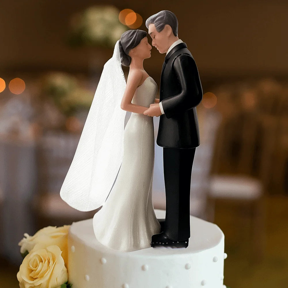 Elegant bride and groom cake topper featuring a couple in wedding attire