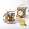 A gift set of soy wax aromatherapy candles in a decorative tin box and glass holder.