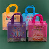 A set of three colorful reusable happy birthday gift bags in orange, blue, and pink.