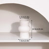 A white minimalist ceramic vase shown on a shelf with dimension markings.