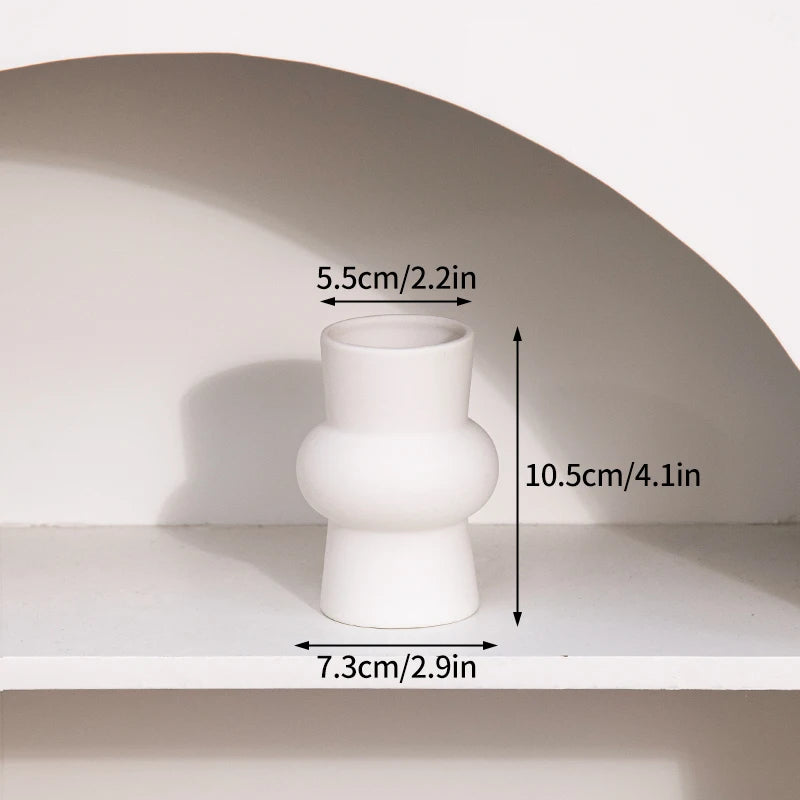 A white minimalist ceramic vase shown on a shelf with dimension markings.