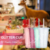 A set of pink, teal, and white glitter plastic cups with lids and straws for parties and events.