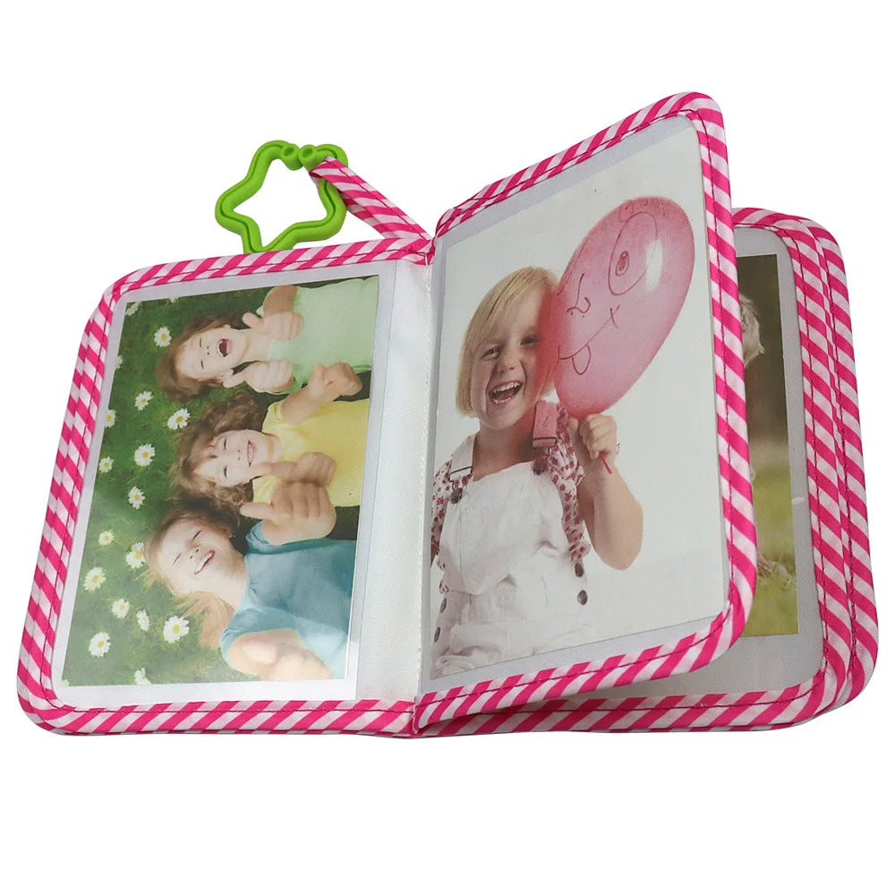 A pink and white striped photo album with a green elastic closure displaying baby photos.