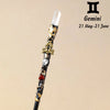 A natural clear quartz zodiac crystal wand with gold accents and a clear crystal tip.