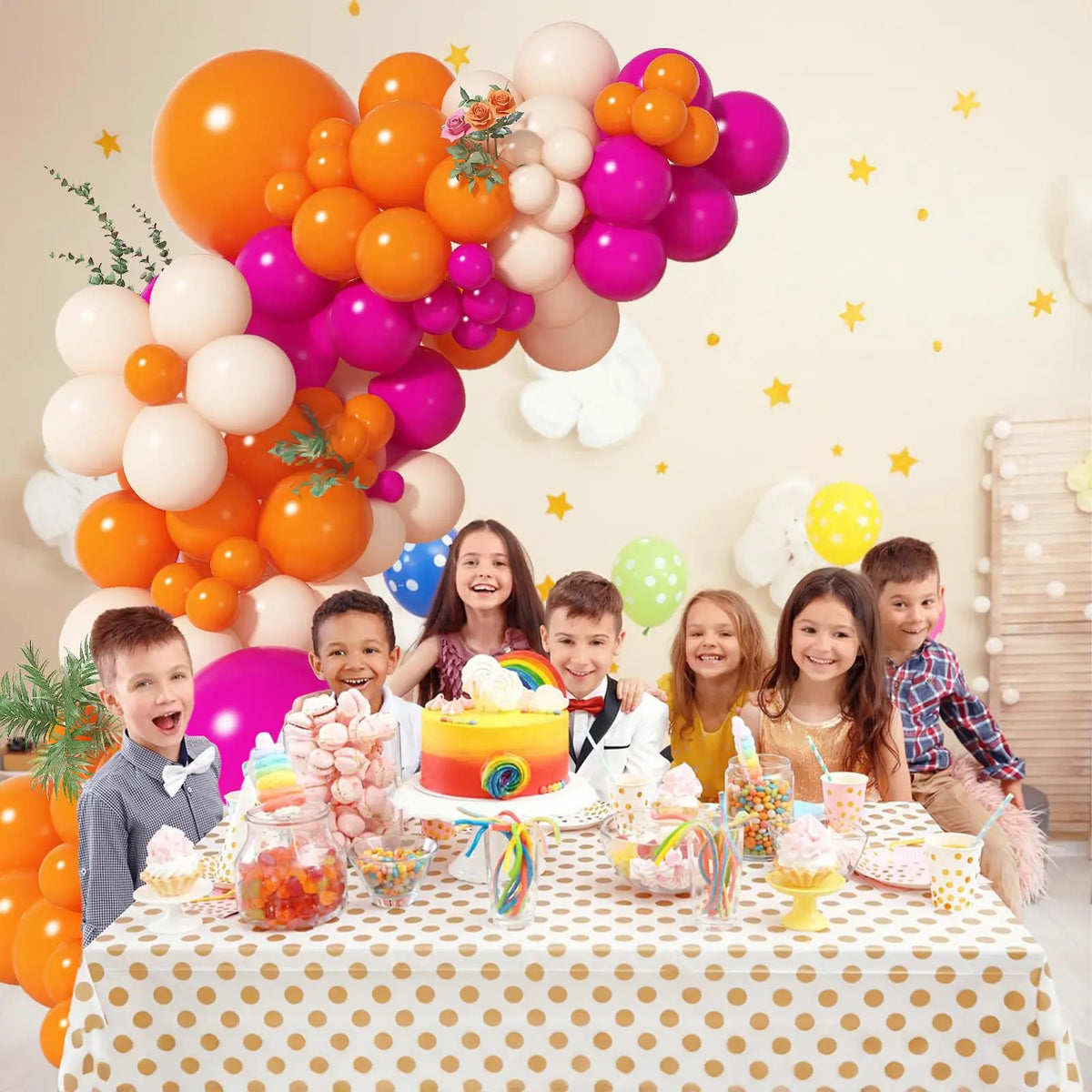 A colorful balloon garland arch kit featuring pink, orange, and purple balloons decorated with children for a party.