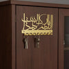 A wooden cabinet features an Islamic Arabic blessing sign with hooks for keys.