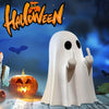 A white ghost figurine with an expressive hand gesture stands in front of a carved pumpkin and Halloween text.