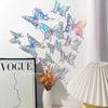 A set of 3D hollow butterfly wall stickers in gold and silver metallic decor displayed on a white wall.