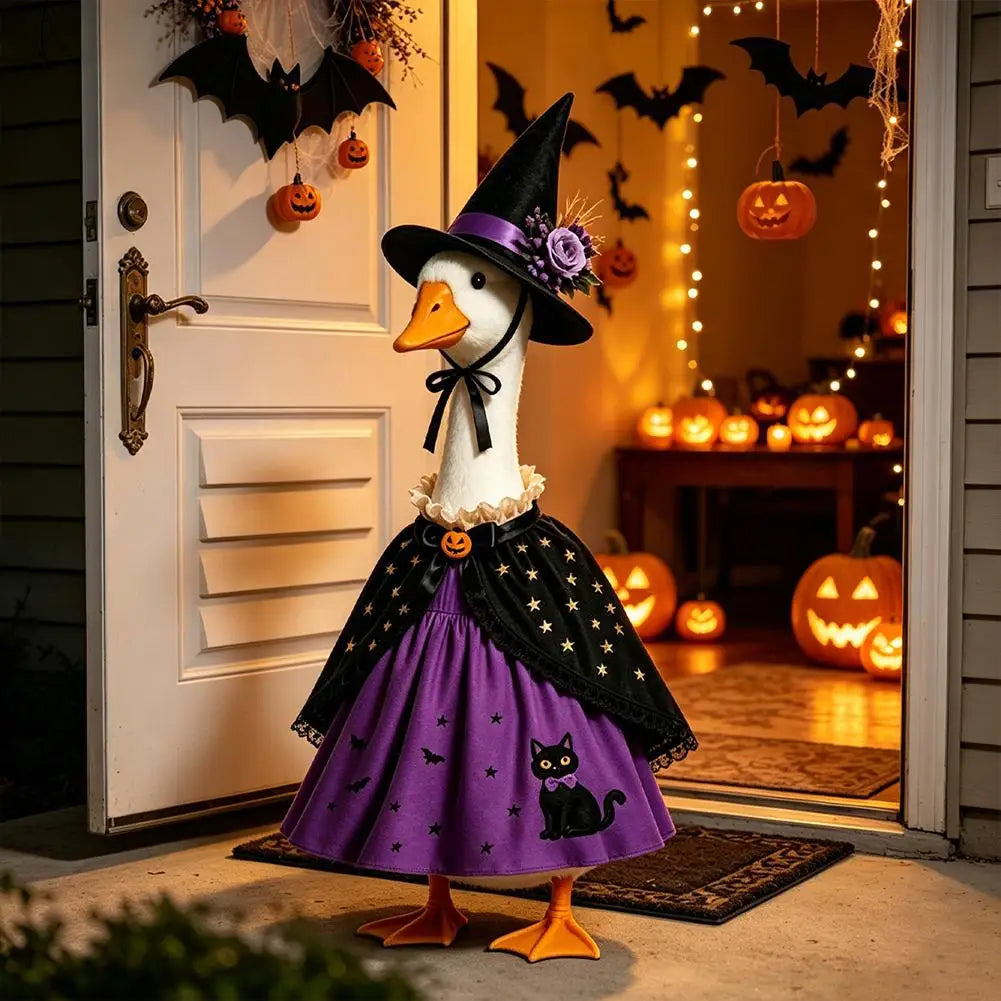A white goose costume wearing a witch hat, cape, and purple skirt with black cat design, standing in front of a door decorate