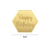 A gold hexagonal acrylic birthday topper with the words Happy Birthday engraved on it.