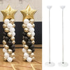 A display of gold and silver balloons arranged in a tall column stand.