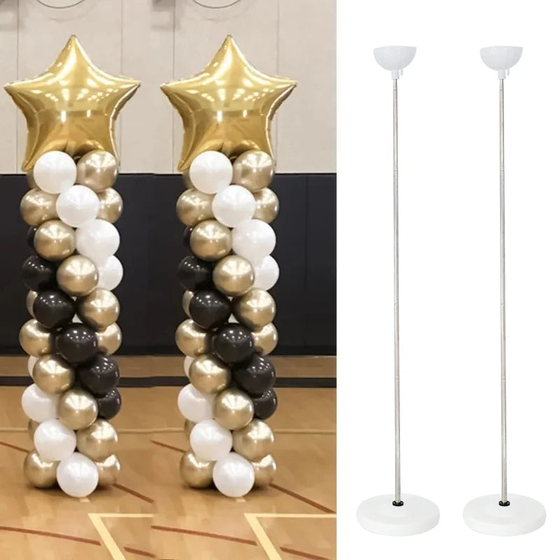 A display of gold and silver balloons arranged in a tall column stand.