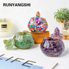 A collection of colorful crystal bowls and an aroma candle displayed on a white surface.