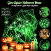 Green glow spider web and fake spiders Halloween decor with pumpkins and ghost figures