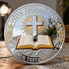 A silver commemorative coin featuring a cross design and Latin text on the obverse.