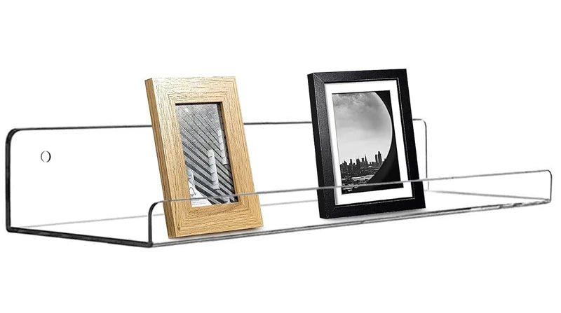 A clear acrylic floating storage rack set displaying two framed photos, one wooden and one black.