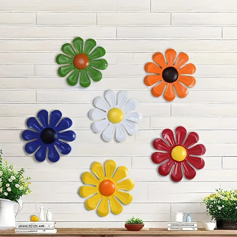Iron sunflower wall art decor featuring various colored metal flowers mounted on a white brick wall.