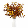 A bouquet of artificial fall eucalyptus stems in shades of brown and gold displayed in a white vase.