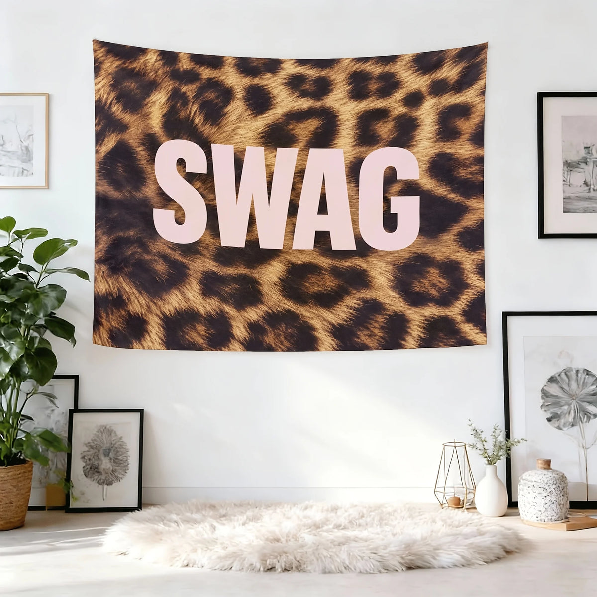 A large tapestry wall hanging featuring the word SWAG in large pink letters on a brown leopard print background.