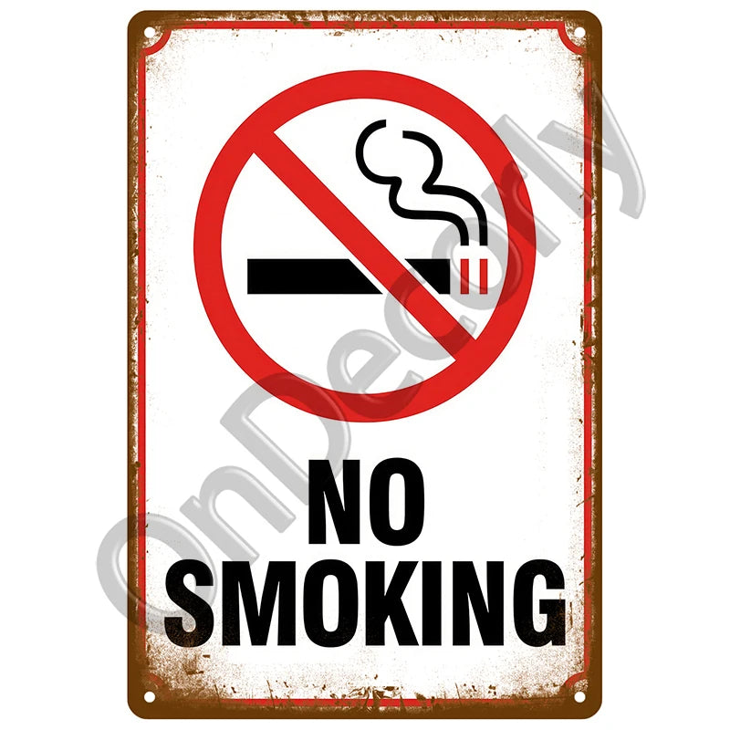 A vintage metal sign with a red border and black text warning against smoking, stating NO SMOKING.