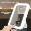 A hand touches a touch screen LED vanity mirror to adjust the light color and brightness.