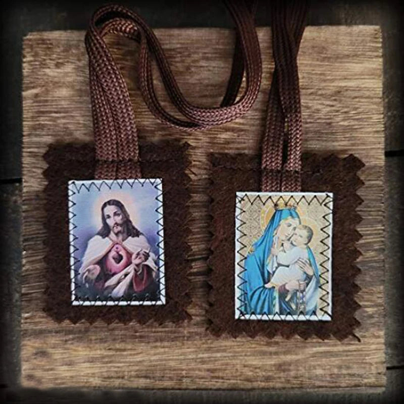 A brown wool scapular with a sacred heart medal and a depiction of the Virgin Mary holding the infant Jesus.
