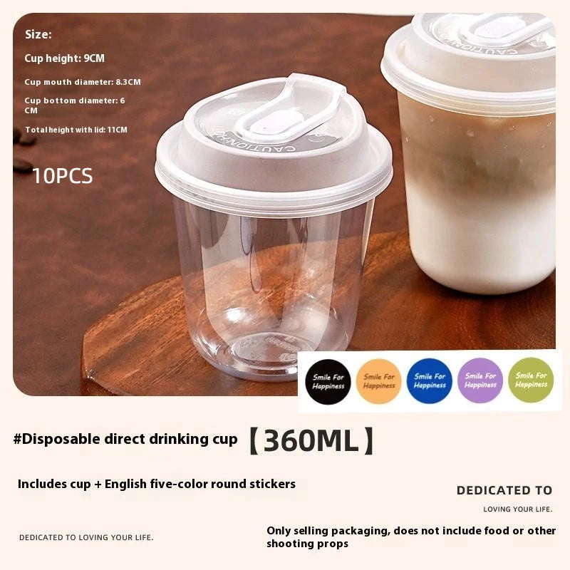 A clear disposable coffee cup with a lid is shown on a wooden surface, next to a white cup.
