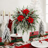 A festive floral arrangement of artificial Norfolk pine branches with red berry stems for holiday decor