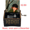 A hand-cranked wooden music box featuring an illustration of a woman, labeled 62-B8.