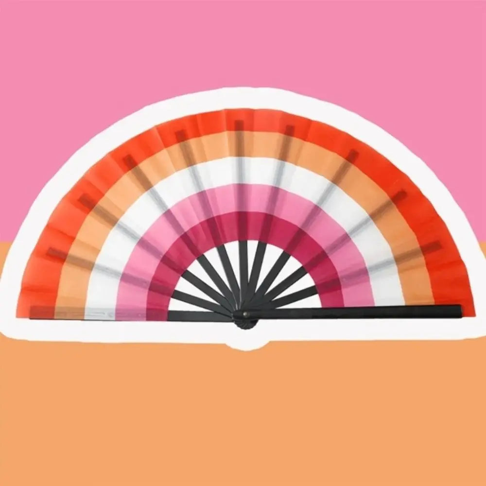 A colorful folding hand fan displaying a rainbow gradient of pink, orange, and white colors.