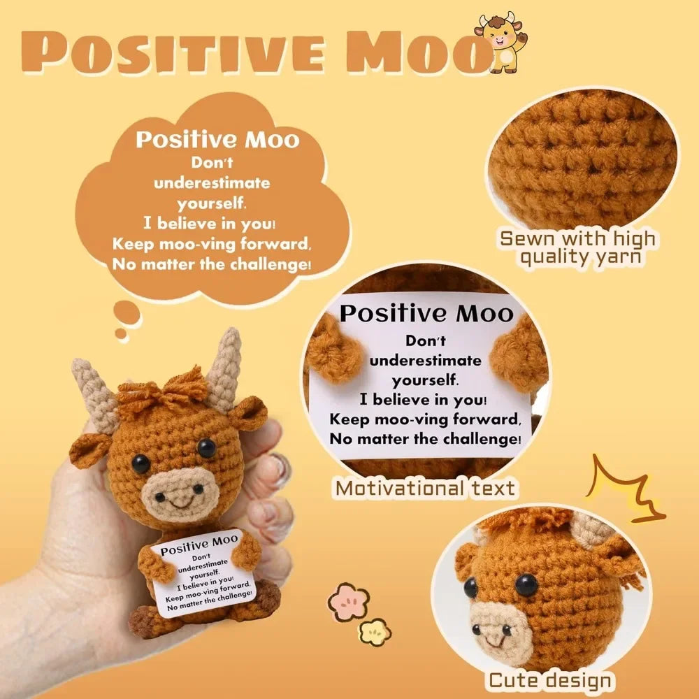 A crocheted Highland cow keychain with a motivational text tag and sewing instructions.