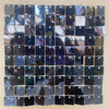 A grid of iridescent sequin shimmer wall panels in various shades of dark blue and black.
