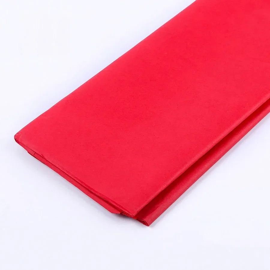A vibrant red tissue paper sheet folded and laid flat.