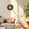 A vintage wooden Last Supper wall clock with a religious scene hangs on a light-colored wall next to a sofa and a modern spea
