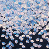 A pile of iridescent blue and pink sea shell PVC sequins for nail art and craft decoration.