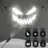 A Halloween ghost and skull projector night light emitting a bright white light through smoke.