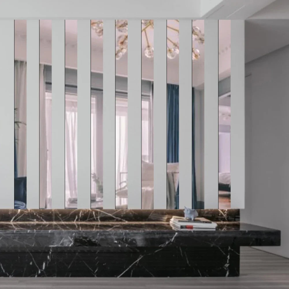 A modern interior featuring a wall of vertical acrylic mirror strips above a dark marble countertop.
