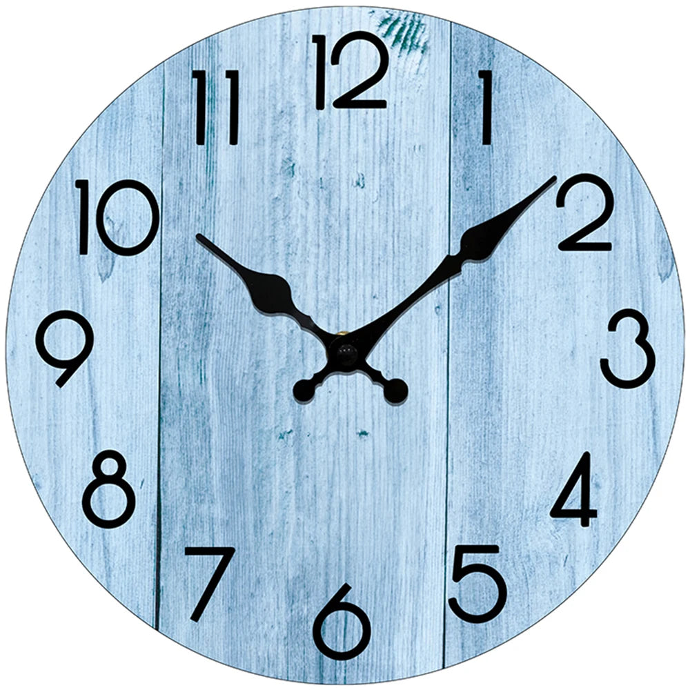 A light blue wooden wall clock face showing the time as approximately 12:00.