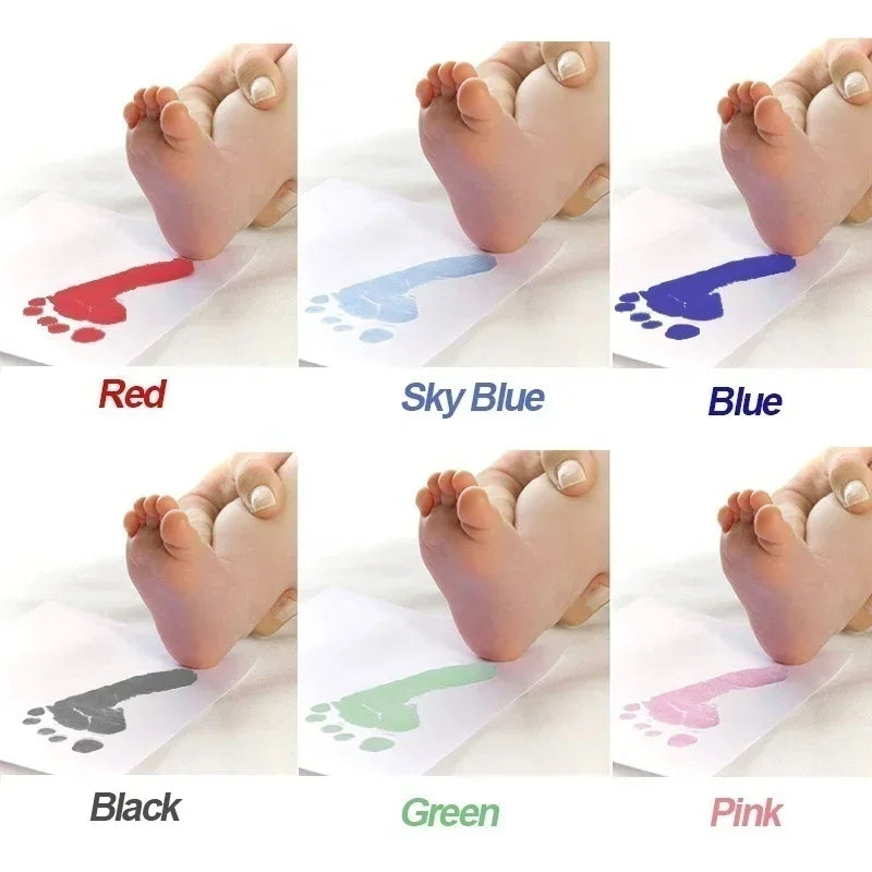 A set of baby handprint and footprint ink pads in various colors including red, sky blue, blue, black, green, and pink.