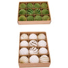 A box containing twelve green velvet Christmas hanging ornaments arranged in a grid.