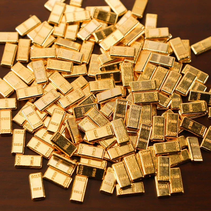 A pile of small, rectangular gold-colored metal prosperity decorations.