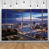 A photographic backdrop featuring a vibrant night city skyline with high-rise buildings and a bridge, viewed through large gl