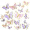 A collection of watercolor paper butterfly cake toppers in shades of purple and pink.