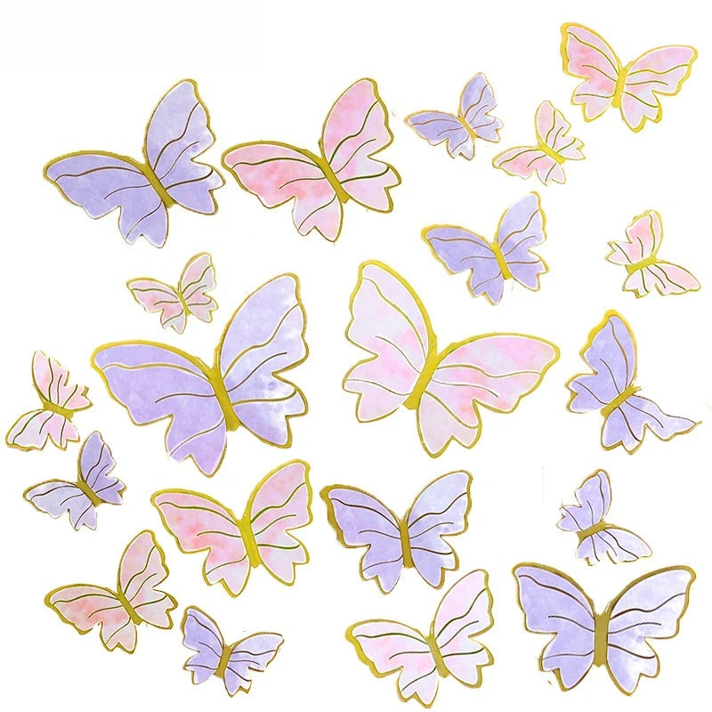 A collection of watercolor paper butterfly cake toppers in shades of purple and pink.