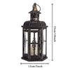 A vintage Nordic iron candle lantern with glass panes, featuring a decorative top and dark finish.