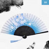 A vintage silk bamboo folding hand fan with blue and white floral designs shown open.