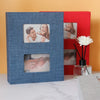 A blue linen-cover photo album displaying several photos of a couple and a woman.