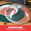Transparent microwave splatter guard with a green base, clear dome, and orange handle.