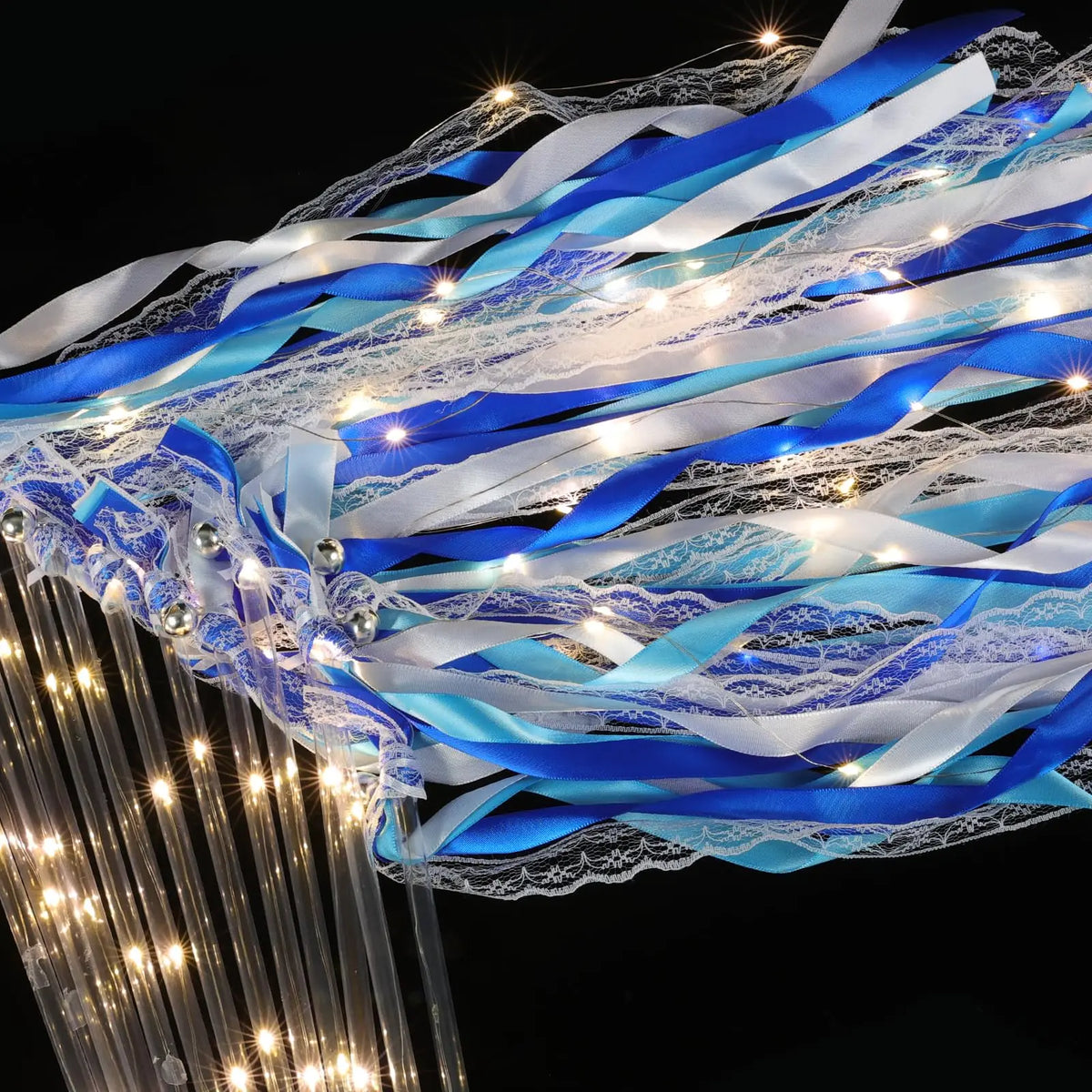 Blue and white LED glow wands with ribbons and bells creating a flowing light effect